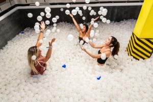 three girls playing with balls in a pool of balls at WOT New Lisbon Social in Lisbon