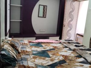 a bed with a quilt on it with a mirror at Mi HOMESTAY in Bikaner +5 photos