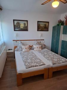 a bedroom with a large bed in a room at KATA VENDÉGHÁZ in Balatonfüred