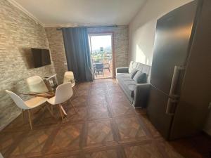 a living room with a couch and a table and chairs at Malibu Ocean View in Adeje +4 photos