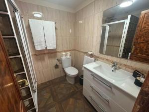 a bathroom with a toilet and a sink at Malibu Ocean View in Adeje