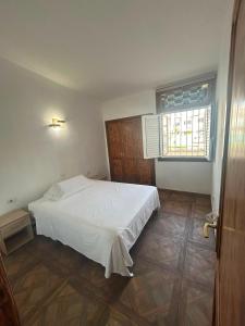 a bedroom with a white bed and a window at Malibu Ocean View in Adeje