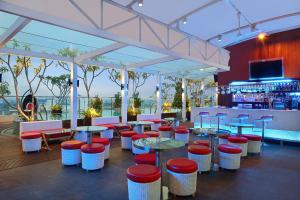 un bar con taburetes y mesas rojos y blancos en ibis Styles Yogyakarta, en Yogyakarta