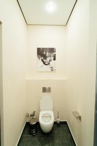 a bathroom with a white toilet in a room at Djasmines Hotel Astana in Astana +75 photos