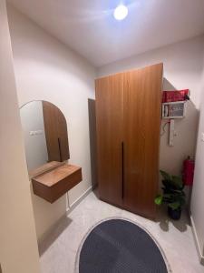 a room with a wooden cabinet and a rug at ليالينا in Dammam +2 photos
