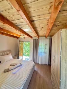 a bedroom with a bed with a wooden ceiling at Lokthi Guesthaose in Theth +27 photos