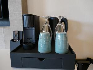 a black stand with two vases on it at Spaarnwoude Park Hotel in Velsen-Zuid