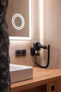 a hair dryer on a wall next to a sink at Aparthotel Maso Corto in Maso Corto