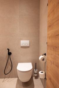 a bathroom with a toilet and two rolls of toilet paper at Aparthotel Maso Corto in Maso Corto