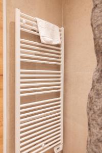 a white towel is hanging on a towel rack at Aparthotel Maso Corto in Maso Corto