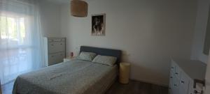 a bedroom with a bed and a dresser and a window at Casa Soria in Pesaro