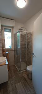 a bathroom with a glass shower and a toilet at Casa Soria in Pesaro +20 photos