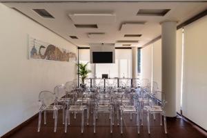a conference room with chairs and a flat screen tv at Best Western Plus Carolus Park Hotel in Sutri