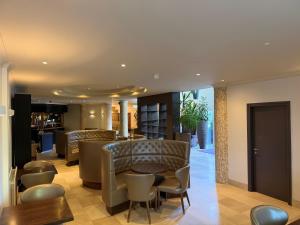 a hotel lobby with chairs and a bar at Wilton Hotel Bray in Bray