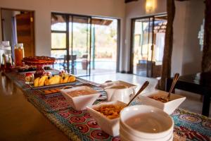 a buffet of food on a table in a room at Lions Place in Grietjie Game Reserve