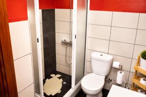 a small bathroom with a toilet and a shower at Spot Matur Apartment in Machico +26 photos