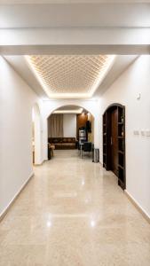 a living room with a couch and a ceiling at Albazar Residence Salalah in Salalah