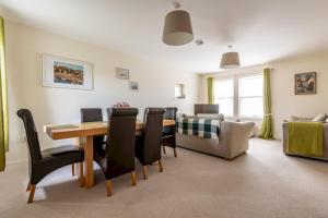 a living room with a table and chairs and a couch at The View, 22 School Park in Kingsbarns