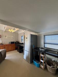 a kitchen with a stainless steel refrigerator in a room at LTB-Waterkant Cottage in Malgas +8 photos