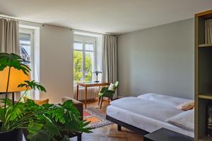 a bedroom with a bed and a desk and window at Krafft Basel in Basel +42 photos