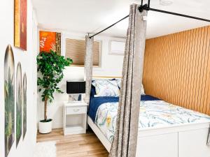 a bedroom with a swing bed in a tiny house at Cozy 2-Bedroom Suite Near Moncton Hospital & NBCC in Moncton