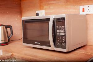 a microwave sitting on top of a counter at Kris Star Lodge in Blantyre