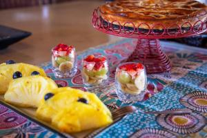 a table with a pie and fruit in small glasses at Lions Place in Grietjie Game Reserve +56 photos