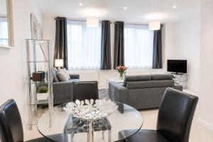a living room with a couch and a table at Roomspace Serviced Apartments - Nouvelle House in Sutton