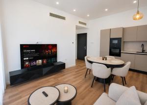 a living room with two tables and a kitchen at Abodos Aqualina D2/1 Fm in Vavilas +10 photos