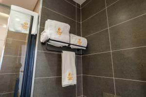 a bathroom with white towels and a shower at Vora Addis Hotel in Addis Ababa +26 photos