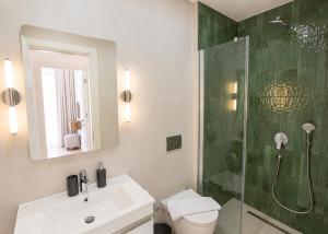 a bathroom with a shower and a toilet and a sink at Abodos Aqualina D2/1 Fm in Vavilas