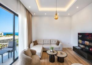 a living room with a couch and a tv at Abodos Aqualina D2/1 Fm in Vavilas