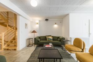 a living room with a couch and a table at Outsite Bordeaux - Work, Connect, Explore in Bordeaux