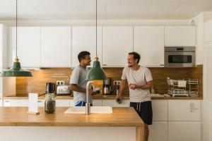 two men standing in a kitchen with a sink at Outsite Bordeaux - Work, Connect, Explore in Bordeaux