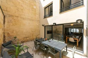an outdoor patio with a table and chairs at Outsite Bordeaux - Work, Connect, Explore in Bordeaux