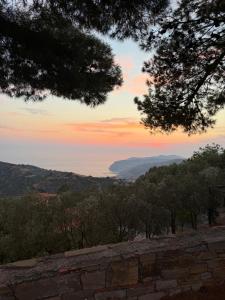 a view of a sunset from a stone wall at Dimora Guariglia in San Mauro Cilento