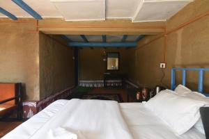 a bedroom with two beds in a room at Idyllic Haven Heritage, Jageshwar in Jageshwar