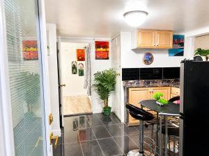 a kitchen with a table and a counter top at Cozy 2-Bedroom Suite Near Moncton Hospital & NBCC in Moncton