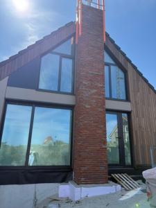 a building being constructed with large windows on it at De Duyn in Midsland