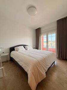 a bedroom with a large bed with a large window at Villa Roja in Bigastro +12 photos