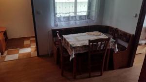 a small table and chairs in a room with a window at Apartmán Marcel - Súľov in Súľov