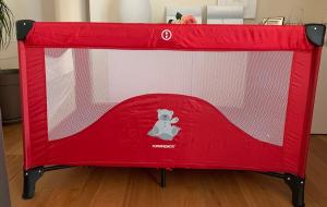 a red canopy bed with a teddy bear on it at Maria Pia's home in Marotta