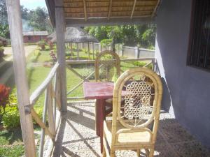 a table and two chairs on a porch at Dimi HOUSE in Andasibe