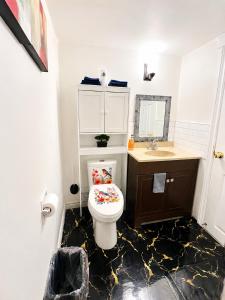 a bathroom with a toilet and a sink at Cozy 2-Bedroom Suite Near Moncton Hospital & NBCC in Moncton +43 photos