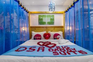 a bedroom with a bed with blue drapes at DSR Blue Suites in Hyderabad +14 photos