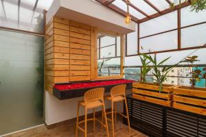 a bar in a room with two chairs and a window at DSR Blue Suites in Hyderabad