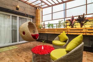 a room with two chairs and a table with flowers at DSR Blue Suites in Hyderabad