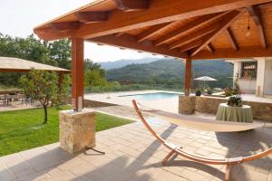 a patio with a hammock and a swimming pool at Dimora Igea b&b in Montano Antilia