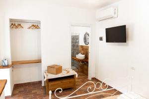 a living room with a tv on a wall at Dimora Igea b&b in Montano Antilia