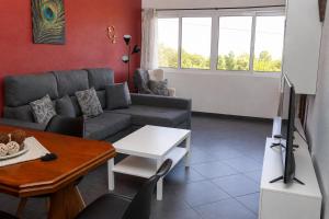 a living room with a couch and a table at Spot Matur Apartment in Machico